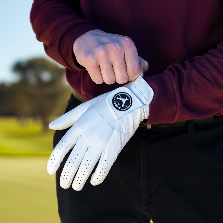 Snowy Owl White Golf Glove being put on hand by Birdova