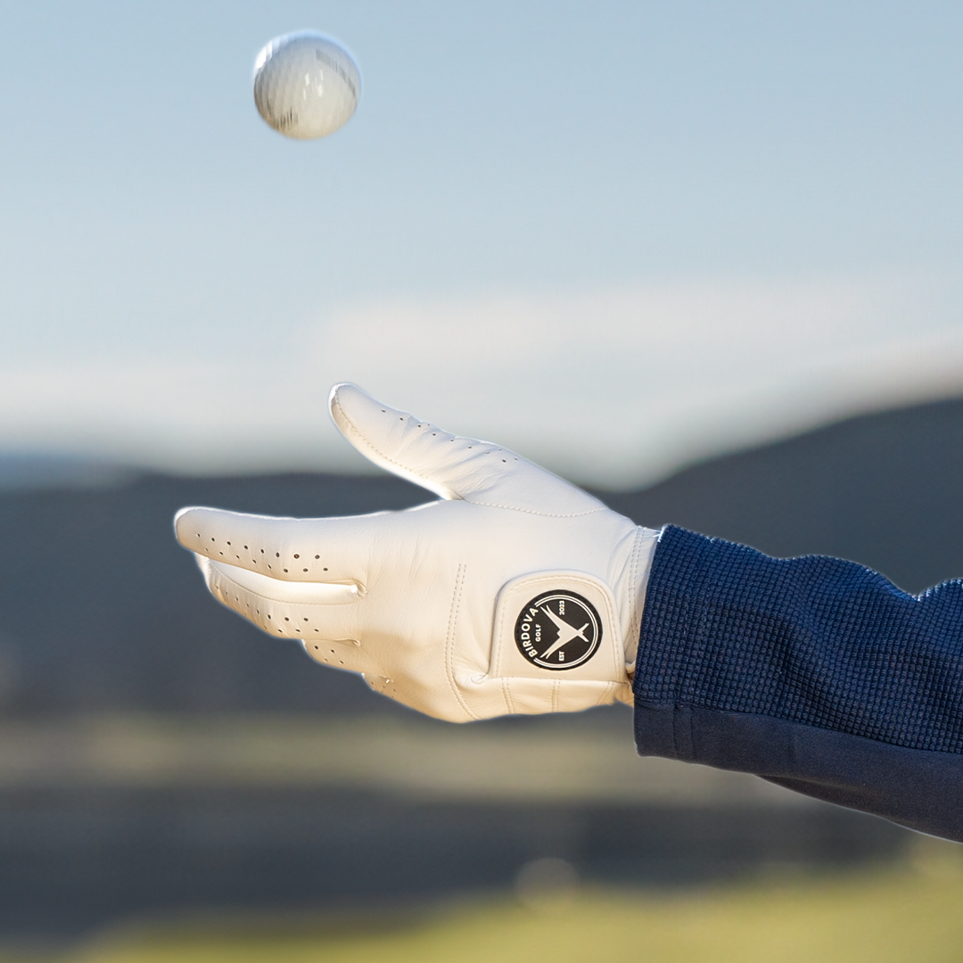 Tossing golf ball with Snowy Owl White Golf Glove by Birdova