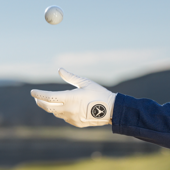 Tossing golf ball with Snowy Owl White Golf Glove by Birdova