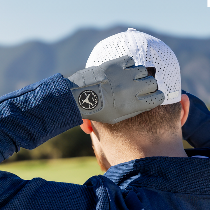 Pigeon Grey Golf Glove fastening cap on course by Birdova